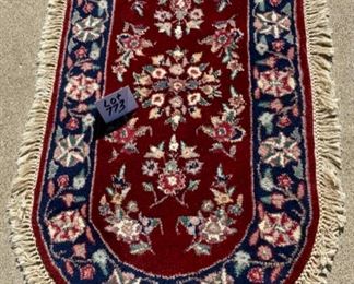 Lot 773.  $150.00.   This is a stunning oval oriental rug feels like wool, no label, but fabric is lined on the reverse. 29"w x 52" l. 