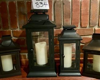 Lot 834. $75. Awesome set of Black Metal and Glass Lanterns in 3 Sizes (17", 14" and 11") with Flameless LED Candle. We believe these are all Pottery Barn