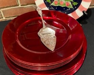 Lot 873.  $25.00. The Holiday Hostess: 8 13" Red Chargers, 8 Red Chargers made of Melanine. 1 11" Cookie Plate and 1 Merry Christmas C\Server