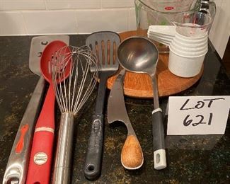 Lot 621. $14.00 Kitchen Utility Lot. Are you a gadget guy or gal?  This lot Includes: spatulas, slotted spoon, ladle, cheese board, and knife, measuring cups and a big wisk.