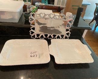 Lot 627.  $30.00. White Grapevine Platter with Handles 18" x 14'' and White Grapevine Platter 19.5 x 13.5" both made by Elios in Italy. Silver Metal Platter with Heart Shaped Border by Inspired Generations.