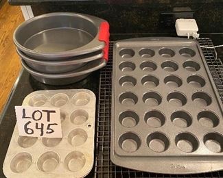 Lot 645. $25.00.  Baking Center (we have several baking pan lots - there are more to come.  This lot includes a large 17.5 x 10.5 Mini cupcake 24 count baking pan, 20x14' cooling rack, 3 kitchen aid 11" cake pans, with red grab-it pads, and two more mini cup cake pans 7-3/4 x 9-3/4"