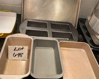 Lot 648.  $20.  1 Wilton 4 mini loaf baking pan, 1 cuisinart 11x6.5" 1 metal 11x8" another unbranded loaf pan, and One 18x13 jelly roll or cookie sheet