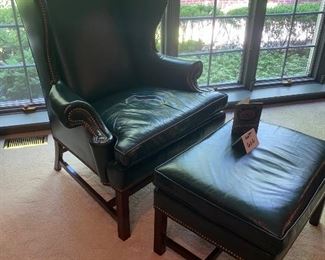 Lot 666. $500.00 Hancock & Moore, green leather wing chair. Wing depth is 16", 46" tall to back of chair
