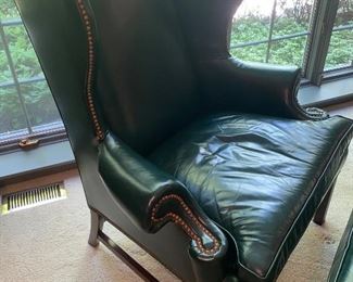 Lot 666. $500.00  Hancock and Moore green leather wing chair and ottoman. Wing depth is 16", the chair is 46" tall to top of the chair back.  Ottoman is green leather 20"x28" top, 17" tall.