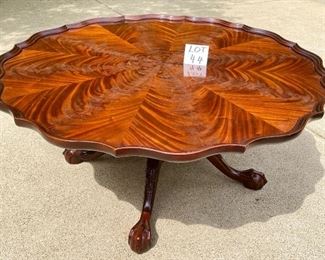Lot 44 $325.00 Pie crust cocktail table with 4 claw and ball feet.  Burlwood starburst wood finish 42" Diameter19.5" tall