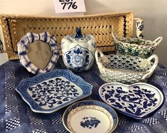 Lot 776.  $65.00.  Blue and White sweetness! Includes: a woven basket with porcelain handles (6"w x17"h). Small hand-painted heart frame, hand painted underplate, small royal Doulton (4.5 in dia) pin dish, Italian made heart dish (6in),  manùfaktùr Walter Germany porcelain handles basket (7"l x 4.5"w), Andrea by Sadek porcelain handles basket (6.5l x 4"w), Flora for Seymour Manning porcelain covered pumpkin (5.5"h x 4.5"w). 