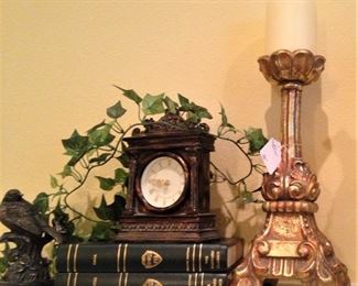 Small decorative clock; one of several gold toned candle holders