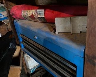 Blue metal tool cabinet; folding lawn chair