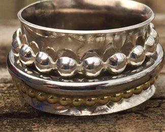 THESE ARE HANDMADE SPIN RINGS THAT REQUIRE YOU TO CALL US SO WE CAN GO OVER ALL THE WONDERFUL OPTIONS YOU WILL HAVE.  OR IF YOU WANT TO TELL US YOUR RING SIZE WE CAN SHOW YOU AVAILABLIBITY OF PREMADE RINGS LIKE ON ABOVE.  BECAUSE OF THE THICKNESS WE RECOMMEND YOU GO A SIZE LARGER.  ALL THREE OF THE MIDDLE RINGS IN THESE SPECIFIC RING CAN BE CHANGED OUT FOR LARGE AVAILABLE CHOICES AT THE TIME OF SALE  