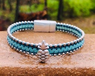 $32 SILVER BEAD LEATHER TURQUOISE WITH PINEAPPLE SILVER CHARM AND MAGNETIC CLASP.  CAN BE MADE TO YOUR SIZE.  PLEASE, CALL 815.519.7653 FOR ANY QUESTIONS.  COMES IN MANY OTHER COLORS.  JUST ASK. AND WE CAN SEND YOU PICTURES.  