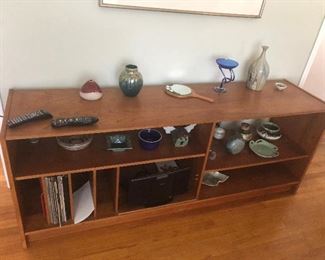 NICE COLLECTION OF SIGNED POTTERY PIECES THIS LONG TABLE BOOKSHELF IS SOLD