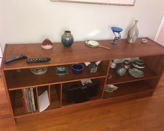 NICE COLLECTION OF SIGNED POTTERY PIECES THIS LONG TABLE BOOKSHELF IS SOLD