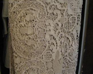 Intricate lace tablecloth made by French nuns