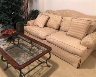 $450 - Hickory Hill down-filled gold-tone sofa with cushions.  $210 - Glass/wrought iron/wood coffee table. 