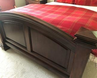 $950 - Footboard view of mahogany queen bed with mattress set. 