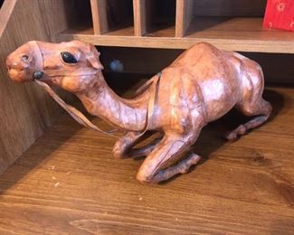 Leather-clad reclining camel figurine