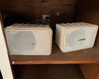 These are Bose speakers.  That's all I know about them - UPDATE: a quick google search revealed that these are Bose 101 Indoor/Outdoor speakers.  Whatever they are, you can have them for the low price of $15