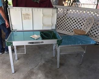 You've got an outdoor kitchen complete with sink, working area and a place to hand all your stuff and hold condiments!  Plus a nice little dinning table attached to the side!  A bargain - never used - at $75