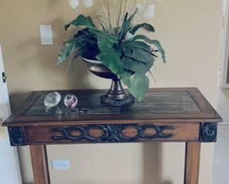 Hall table with floral arrangement.