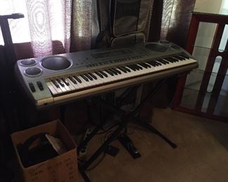Casio WK-1800 keyboard with stand, carrying case & foot pedal.