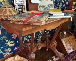 Beautiful antique side table loaded with interesting books, baskets, and paper items
