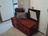 Vintage cedar chest, pillows, and framed crochet handwork.