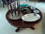 Cherry round coffee table, McCarty pottery,  blue-white bowls, vintage eye glasses and other decorative items.