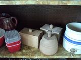 Butter molds, vintage refrigerator containers with lids, and crock with spout.
