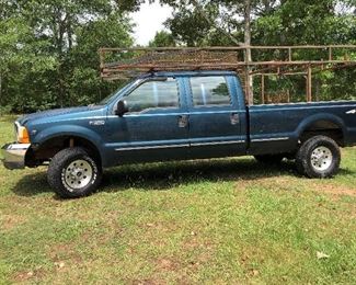 Lot # 40 $5500 ~Ford F250 '99 4X4 - 4 wheel drive/285K miles Hide Away hitch and Gooseneck hitch with work racks, gas (sorry TRUCK not discounted)