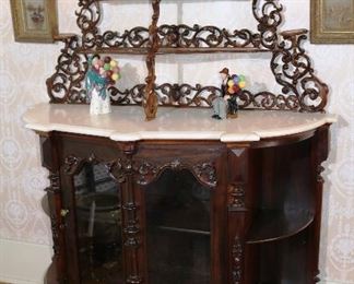 065 - Rosewood rococo parlor etagere with white cut marble top and carved all over, marble has one spot damage, 52 in. W, 70 in. T, 22.52 in. D.