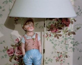 128 - Pair of bisque figurines of boy and girl made into lamps, 27 in. T.