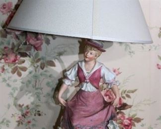 128 - Pair of bisque figurines of boy and girl made into lamps, 27 in. T.