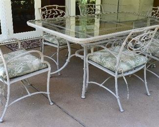 42. Lot F42 (0094.jpg 0095.jpg)  – Tropitone Cast Aluminum, Glass Top - Patio Table with 6 Chairs and Pillows. Table: 72” (6 feet) – long, 41” Wide. Chair: 33” High Back, 21.5” wide.