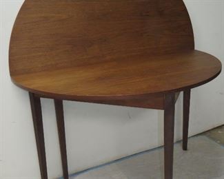 ITEM 11 -- MCM walnut flip top demilune console/dining table, has surface blemishes. open is 48" diameter, 29" high $275.00