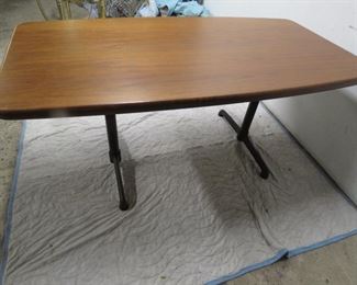 ITEM 20-- Large Walnut table with metal base, signed steelcase. 65" long, 35" wide, 29" high. $375.00