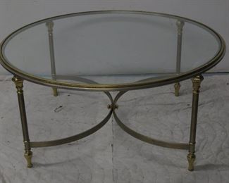 ITEM 25--Hollywood regency steel brass round glass coffee table. 37 1/2" diameter, 17 1/2' high. $225.00