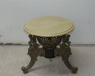 ITEM 68---Classical style figural gilt metal, composition marble top pedestal with cherubs. 18" high, 18" diameter, 24' base width at feet. $100.00