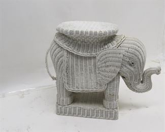 ITEM 87---wicker elephant table / plant stand, tail is loose at bottom. 26" long, 10" wide, 20" high. $40.00