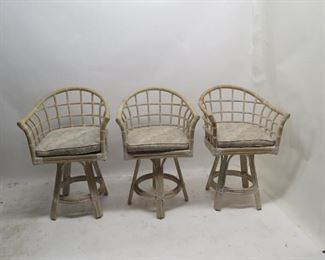 ITEM 99---3 rattan swivel bar stools w cushions, 1 w/ rips and stains, 24 3/4w, 19" deep, 38.5" high, 22.5" high to seat. $ 150.00
