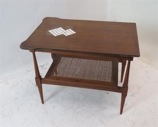 ITEM 126---MCM end table with tile inserts and caned base. [surface crackling} 19.5" wide, 27 3/4" deep, 21 1/4" high $150.00