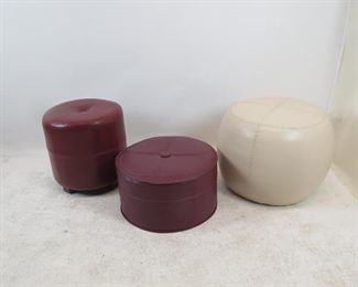 ITEM 138 ---3 contemporary ottomans, white leather is scuffed 22" diameter, 17" high, tall burgundy 17" diameter, 17" high, short burgundy,19.75" diameter, 10" high $60.00