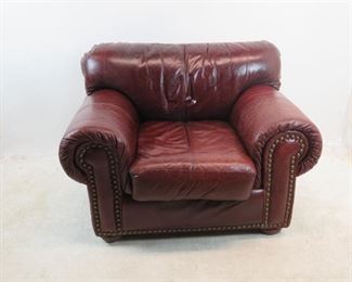 ITEM 154 ---Robinson and Robinson leather arm chair with brass tacking. 48" wide,39" deep, 35" high. $500.00