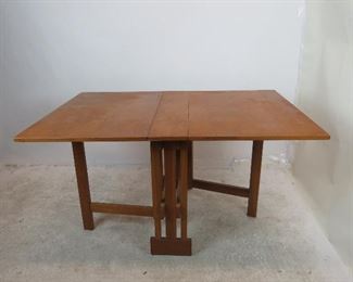 ITEM 209---MCM dropleaf folding table. Has some chips, veneer loss, scratches. 36" x open 54" , 2-23.5" leaves, 7' center, closed--36" deep, 9" wide, $225.00