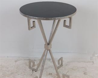ITEM 218 --- contemporary silvered metal table with black acrylic top. 18" diameter, 26.25" high $50.00