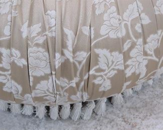 upholstered pleated ottoman on legs, missing a couple tassels. PIC 2