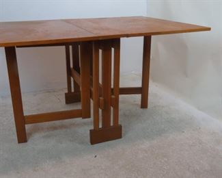 MCM dropleaf folding table. Has some chips, veneer loss, scratches. PIC 5
