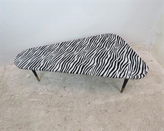 ITEM 300--MCM zebra pattern boomerang coffee table. minor stain, fabric lifting at ends. 48" long, 26.45" wide, 15.25" high. $175.00