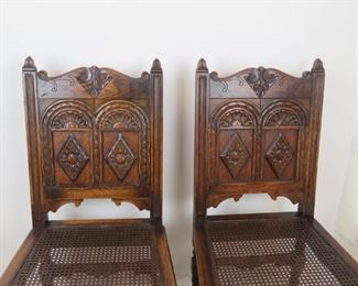 ITEM-358-- Pair of Carved Jacobean oak cane seat chairs. chip missing on runner, roughness and chips PIC 2