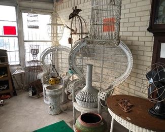 Green Patio Room with 3 vintage wicker Peacock chairs, vintage bird cages wicker and metal, wonderful mosaic plant stands and vases.